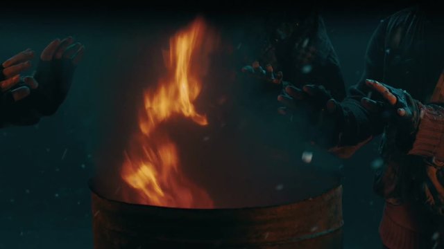 Homeless people warming near fire barrel. Warming hands on barrel fire. Warming hands fire barrel. Close up of fire flames warm up people hands