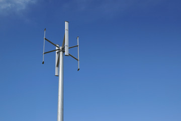 Wind power turbine in a power generation plant. Blue sky and empty copy space for Editor's content.