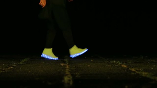 closeup of feet to dance in shoes that glow in the night