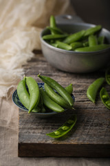 Sugar snap peas. Dark rustic photo