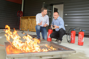 Men training with fire extinguishers