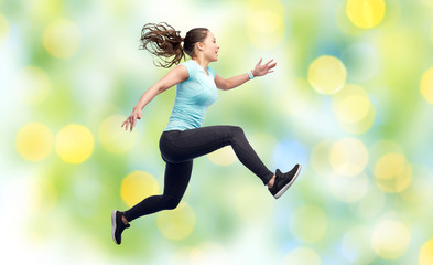 Fototapeta na wymiar happy smiling sporty young woman jumping in air