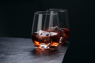 whiskey with ice on a wooden table