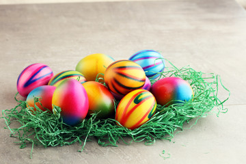 Row of Easter eggs on stone table