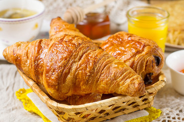 Croissants pastry for breakfast with tea and orange juice