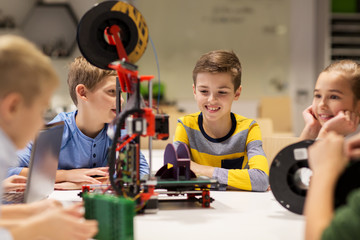 happy children with 3d printer at robotics school