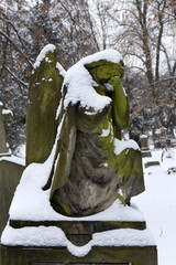 Winter snowy mystery old Prague Cemetery Olsany with its Statues, Czech Republic