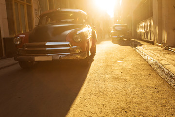 Old car on street of Havana at sunset, Cuba