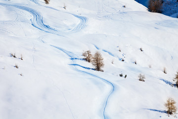 Skiers curves on the snowcapped mountains slopes