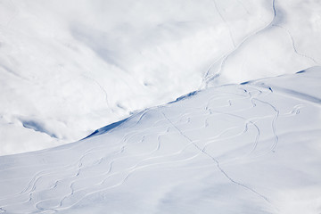 Snowy mountain cowered with curving skiing traces