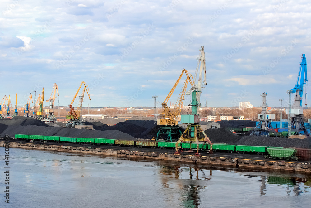 Wall mural Baltic coal terminal with port cranes near the river. Riga cargo