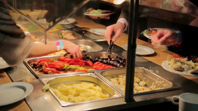 People impose food. Catering. Impose Salad. Food Distribution Table.