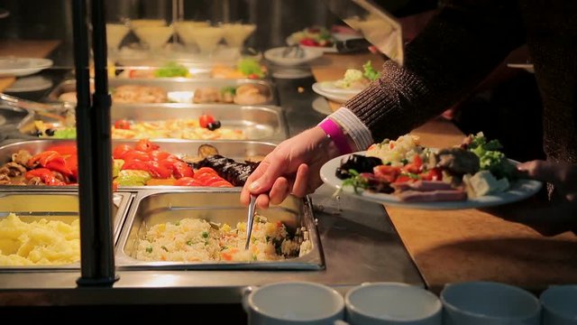 People impose food. Catering. Impose Salad. Food Distribution Table.