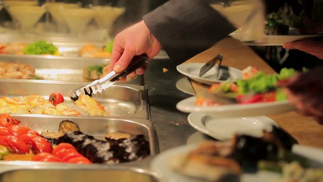 People impose food. Catering. Impose Salad. Food Distribution Table.