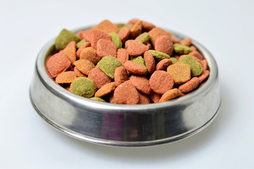 Dog food in the bowl on light background