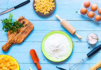 Pasta background. Several types of pasta with vegetables,  Free space for text. Top view