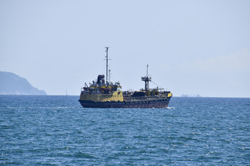 Fototapeta na wymiar Ships on the horizon of the sea. Out at sea ships