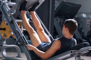 Athletic man training in modern gym