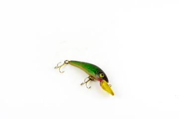 Exhibition of pirate copies of baits for fishing traps. Bait for fishing in the shape of a spoon with a hook on a white background.