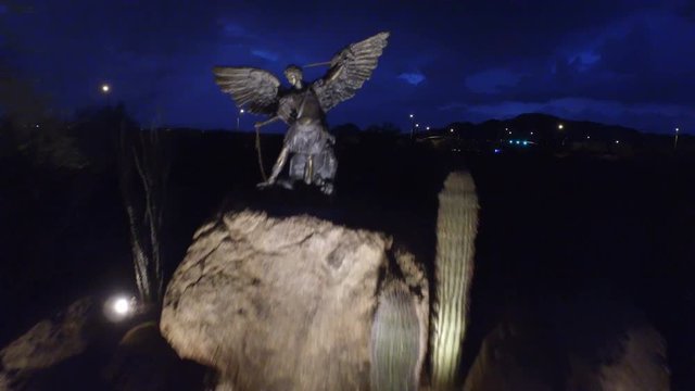 Aerial Flight Over Angelic Statue / Aerial over a Catholic Church statue in Arizona during a thunderstorm and mountain background/
