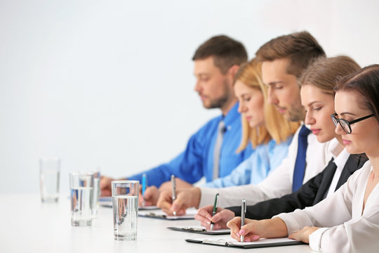 Human resources team sitting in a row at table in office