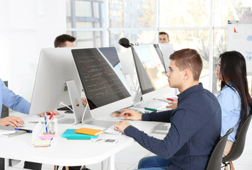 Young programmers working in office