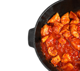 Frying pan with delicious chicken tikka masala isolated on white