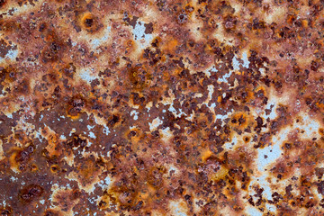 Rusty metal background with traces of old light blue paint