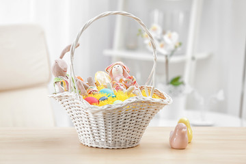 Fototapeta na wymiar Easter basket with gifts on blurred background