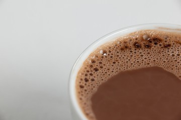 Close-up of white coffee cup with froth