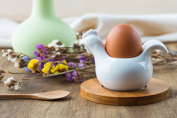 Egg, flowers on wooden background. Easter table