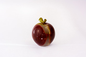 Apple made of onyx stone on a white background