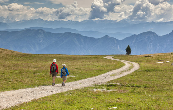 Hikers in the solitary Pian della Nana, Brenta dolomites, Italy