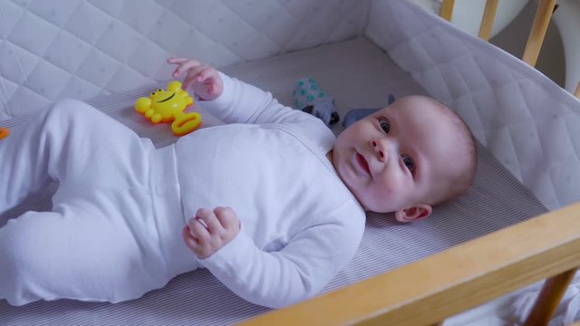 Innocent baby smiling and playing with toys