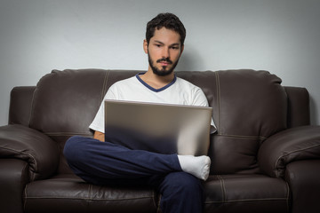 Focused man working hard at home.