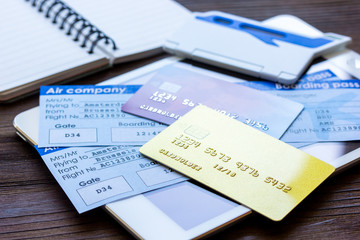 Buying airline tickets online with credit cards on table background