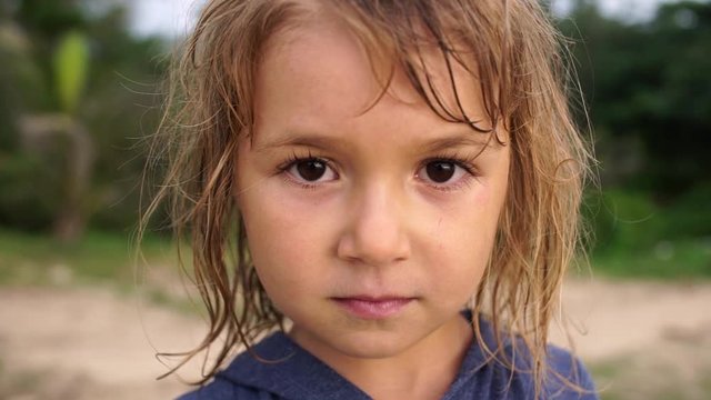 Portrait adorable 5 year old girl with wet hair outdoor