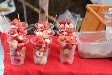 Fresh strawberry in plastic cup ready for sale.