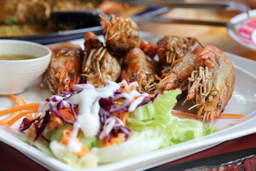 Thai food, fried prawns with salt and chili serve with fresh vegetable salad dressed with mayonnaise.