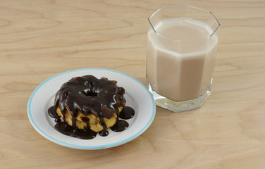 Triple chocolate breakfast with chocolate kefir and chocolate frosted donut smothered by chocolate syrup