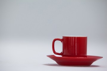 Close-up red coffee cup and saucer