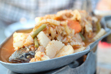 Thai food, spicy sour soup with striped snake-head fish and vegetable.