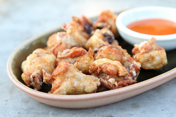 Thai food, deep fried chicken with chili sauce.