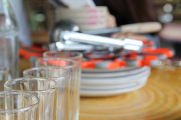 Row of empty water glass on wooden table.
