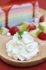 Whipped cream on wooden plate.