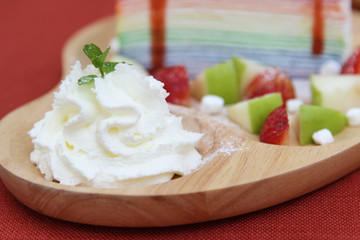 Whipped cream on wooden plate.
