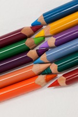 Fototapeta premium Colored pencils arranged in interlock pattern 
