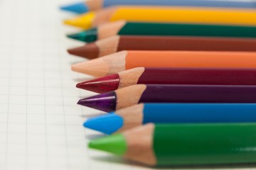 Close-up of colored pencils arranged in a row