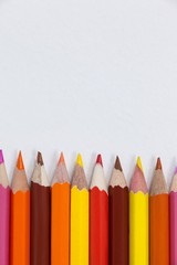 Close-up of colored pencils arranged in a row