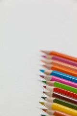 Close-up of colored pencils arranged in a row